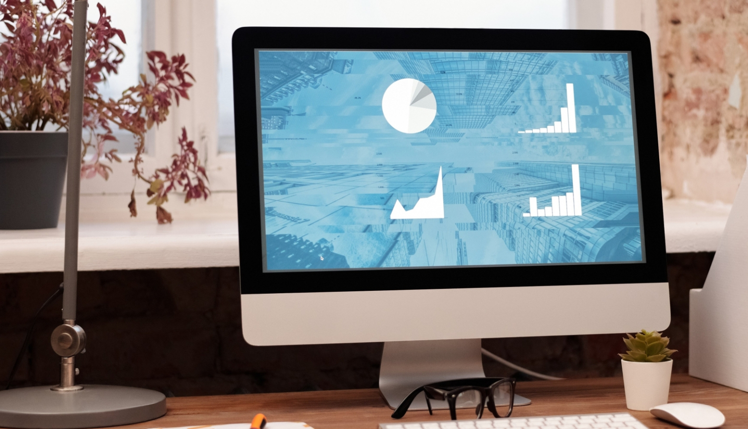 Attēls ar datora monitoru, uz tā redzami grafiki